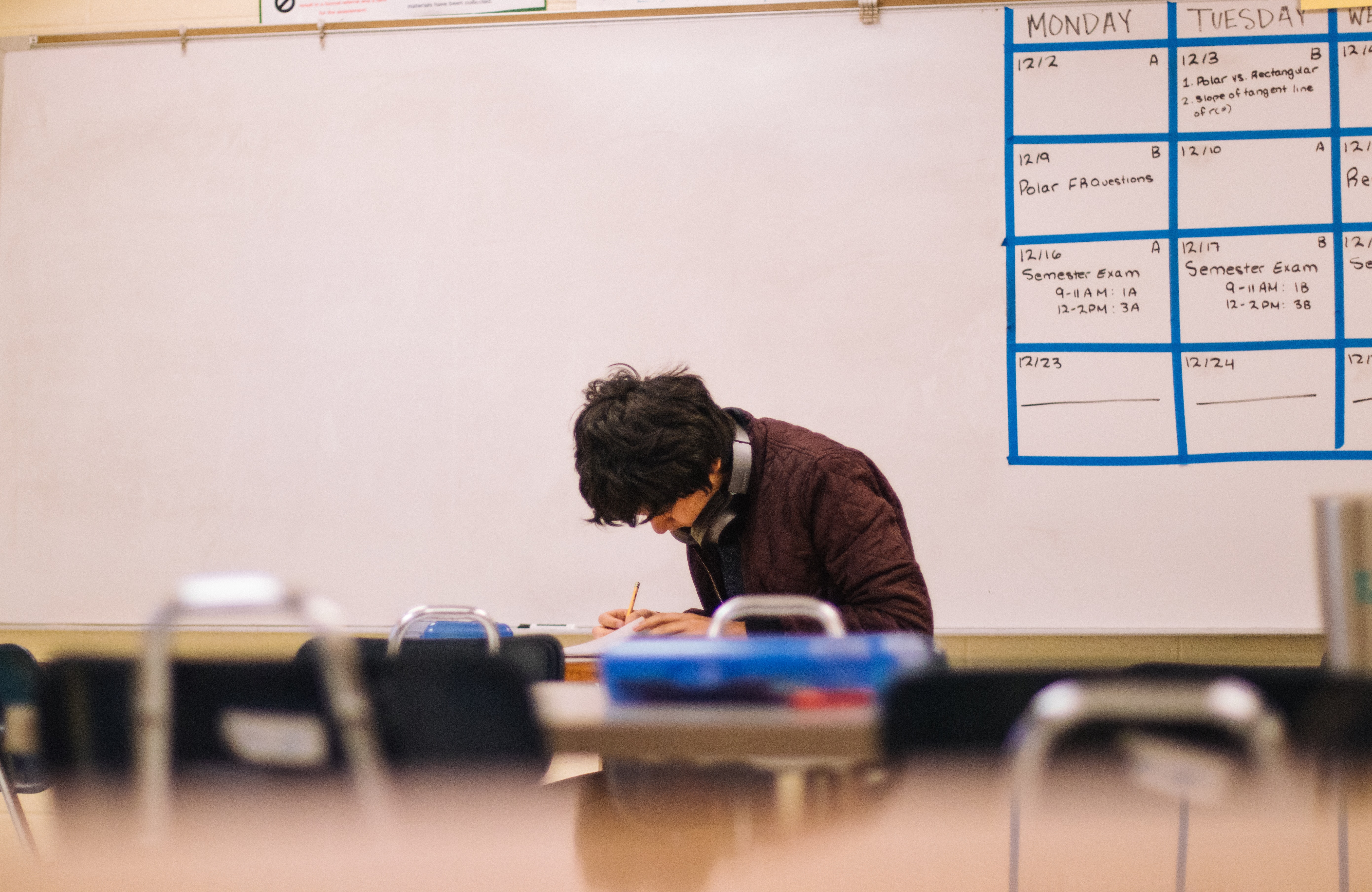 Student in classroom doing homework.
